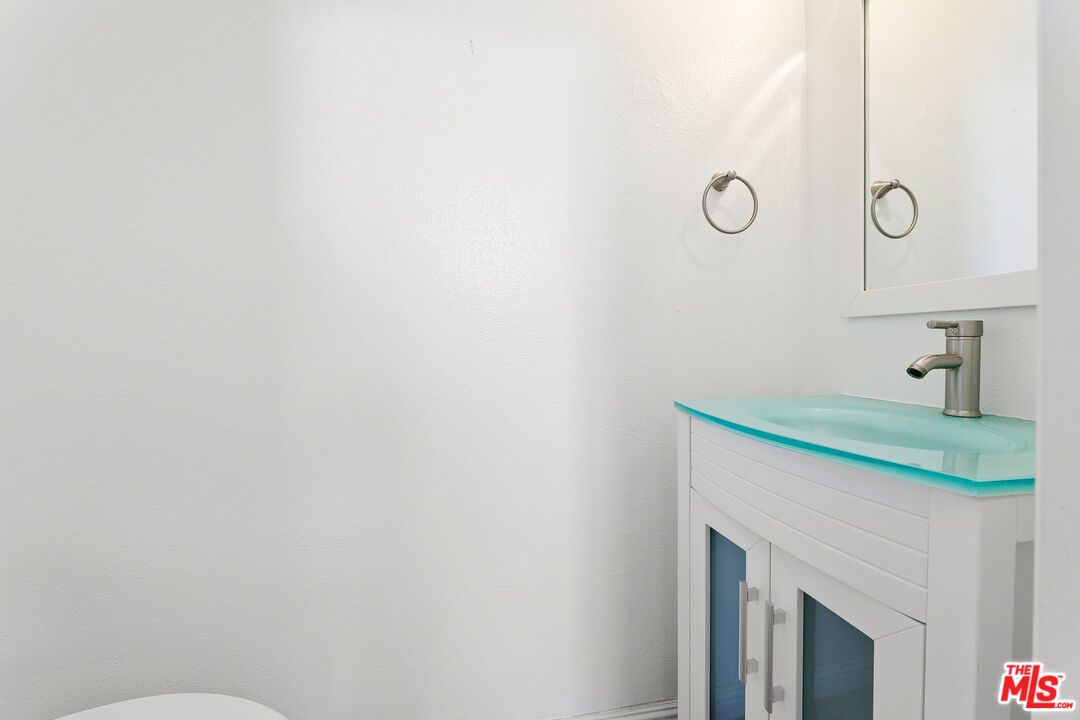 28398 Rey De Copas Lane Malibu, CA 90265 - Photo 19 of 44 a bathroom with a sink and a mirror