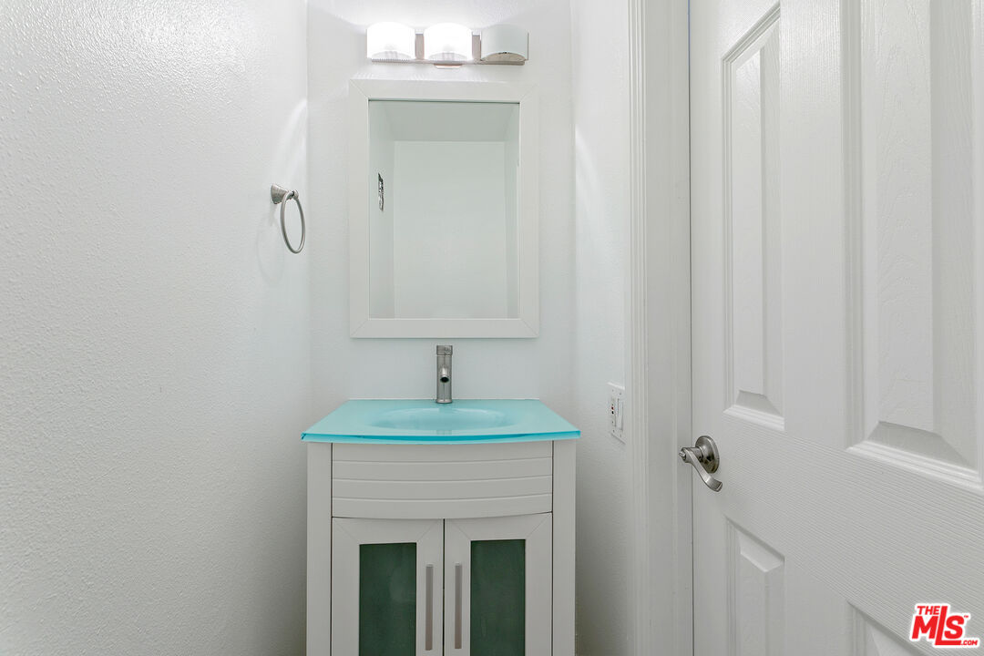 28398 Rey De Copas Lane Malibu, CA 90265 - Photo 20 of 44 a bathroom with a sink and a mirror
