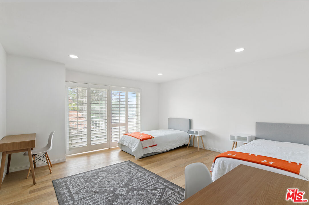 28398 Rey De Copas Lane Malibu, CA 90265 - Photo 22 of 44 a bedroom with furniture and wooden floor