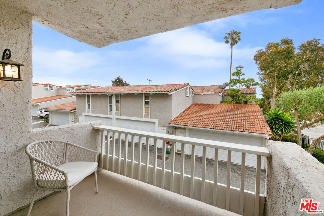 28398 Rey De Copas Lane Malibu, CA 90265 - Photo 25 of 44 a view of a chairs and table on the terrace