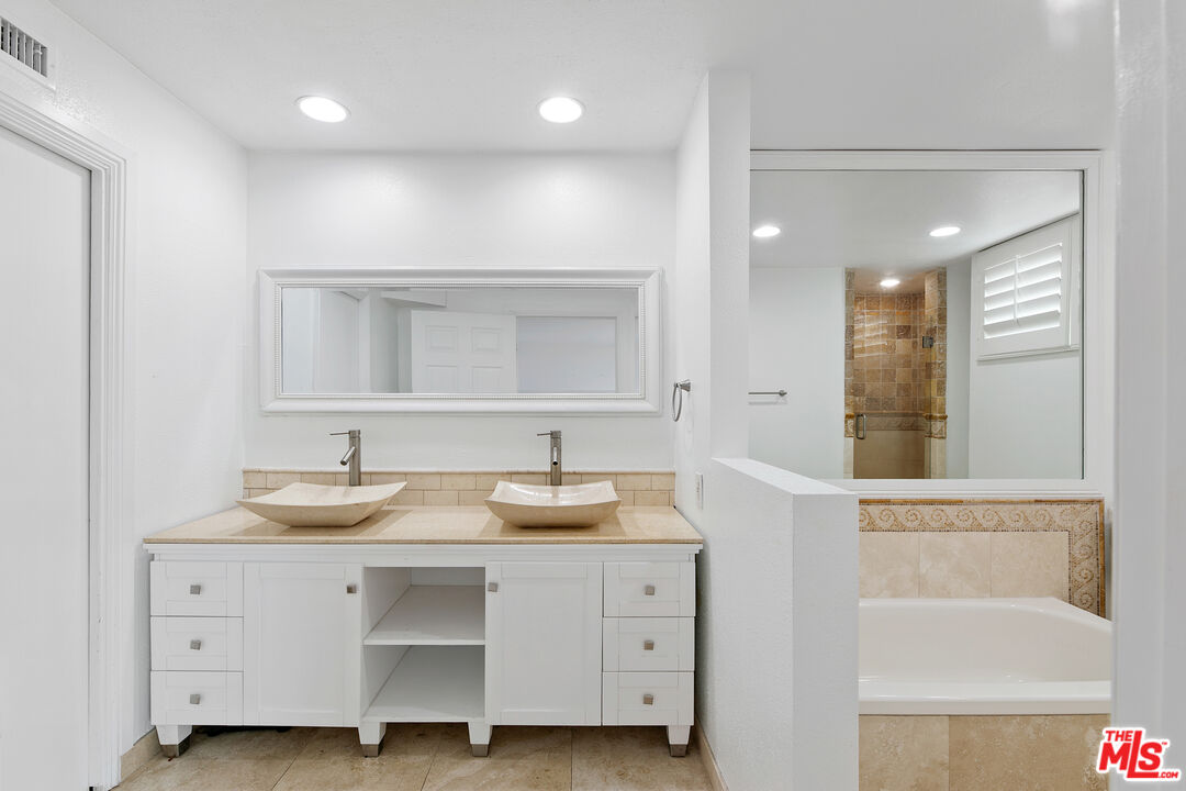 28398 Rey De Copas Lane Malibu, CA 90265 - Photo 26 of 44 a bathroom with a sink and a mirror