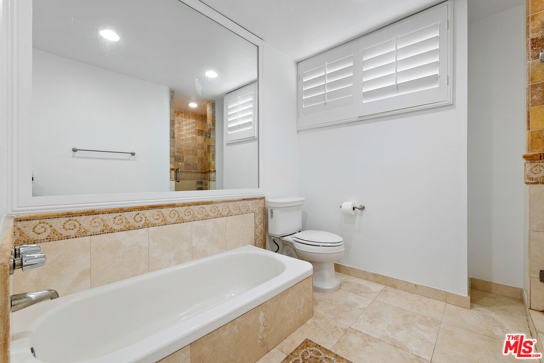 28398 Rey De Copas Lane Malibu, CA 90265 - Photo 27 of 44 a bathroom with a bathtub and a toilet