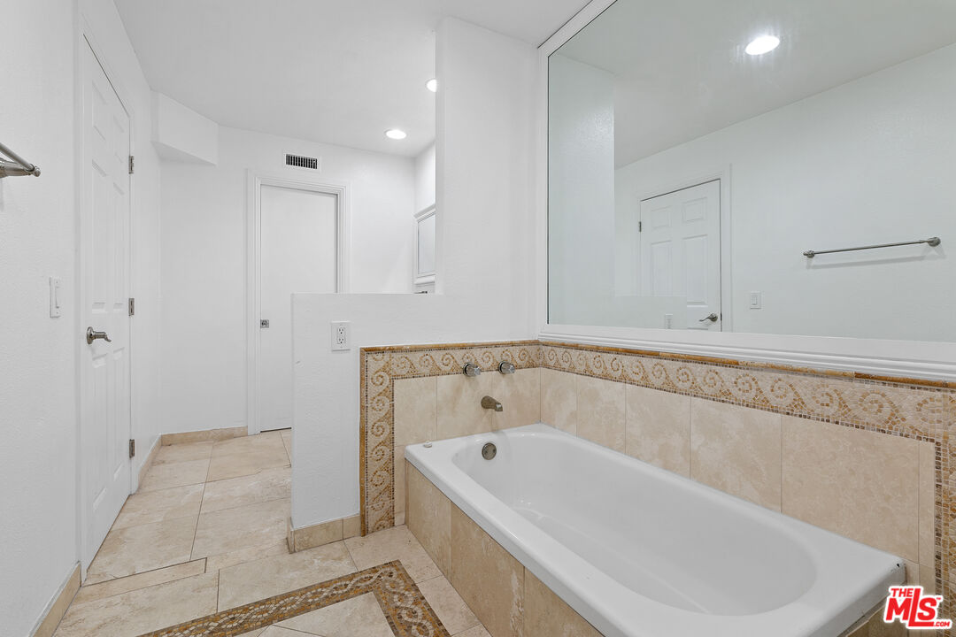 28398 Rey De Copas Lane Malibu, CA 90265 - Photo 28 of 44 a bathroom with a bathtub and shower