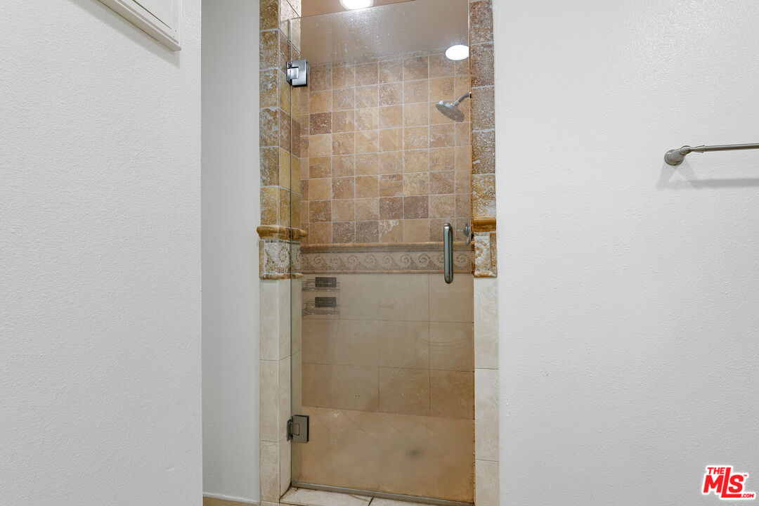 28398 Rey De Copas Lane Malibu, CA 90265 - Photo 29 of 44 a bathroom with a glass shower door