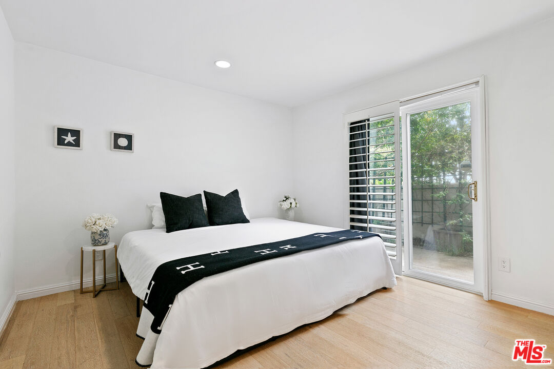 28398 Rey De Copas Lane Malibu, CA 90265 - Photo 33 of 44 a large bed sitting in a bedroom next to a window