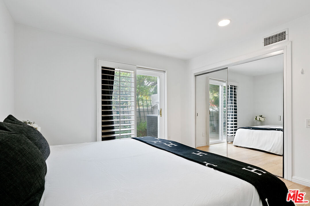 28398 Rey De Copas Lane Malibu, CA 90265 - Photo 34 of 44 a bedroom with a bed and a large mirror