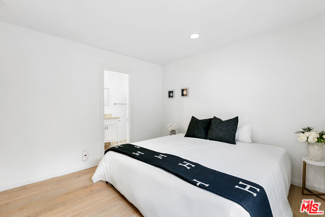 28398 Rey De Copas Lane Malibu, CA 90265 - Photo 35 of 44 a bedroom with a bed and a potted plant
