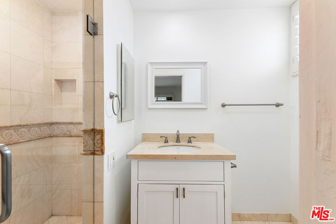 28398 Rey De Copas Lane Malibu, CA 90265 - Photo 36 of 44 a bathroom with a sink and a mirror