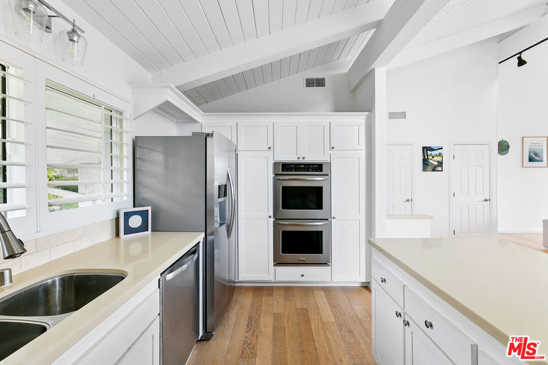 28398 Rey De Copas Lane Malibu, CA 90265 - Photo 9 of 44 a kitchen with kitchen island a sink appliances and cabinets