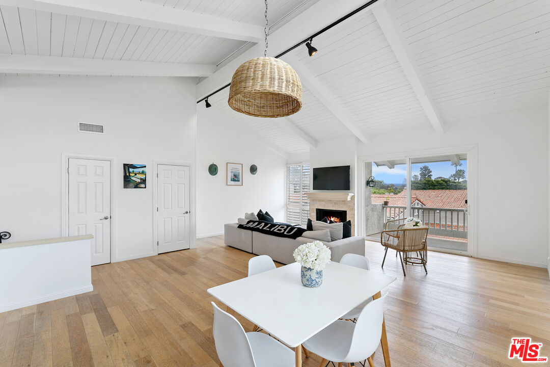 28398 Rey De Copas Lane Malibu, CA 90265 - Photo 10 of 44 a view of a dining room with furniture and wooden floor