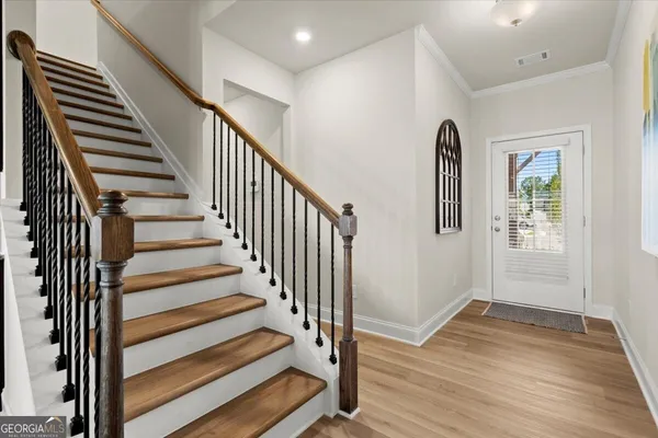 a view of entryway with wooden floor and stairs