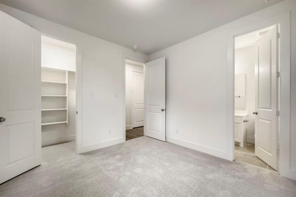 11548 Wulstone Road Haslet, TX 76052 - Photo 21 of 26 Spacious room featuring light gray carpet flooring, white walls, and bright overhead lighting