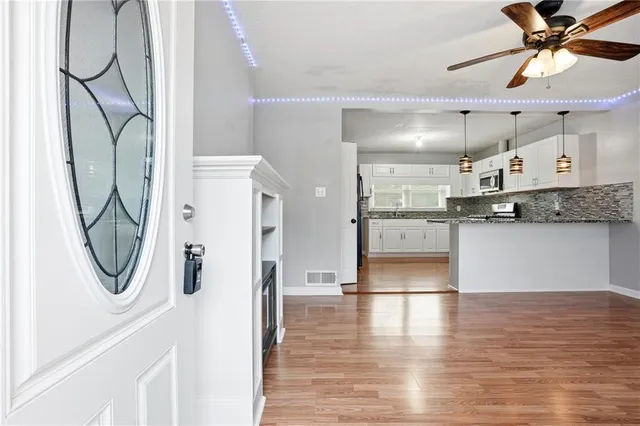 a view of a kitchen with a sink and cabinets