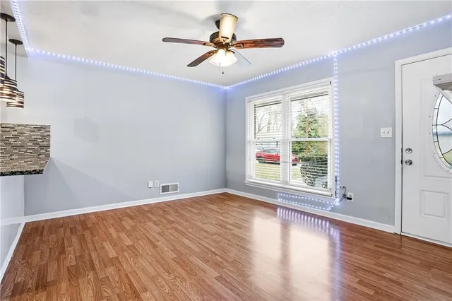 a large kitchen with granite countertop a large counter top space appliances and cabinets