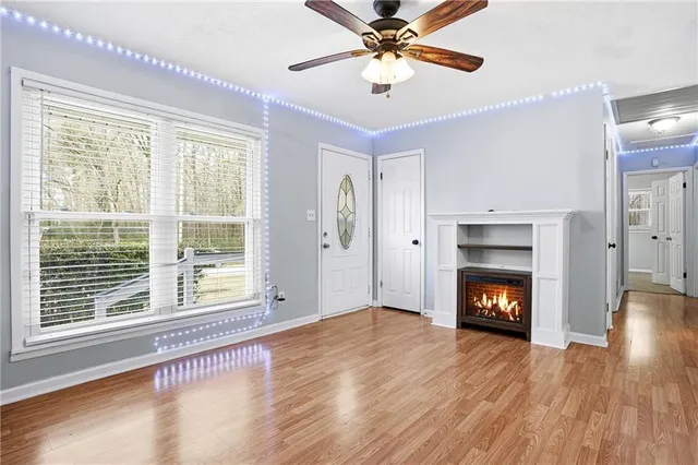 a kitchen with stainless steel appliances granite countertop a sink a refrigerator and a wooden floor