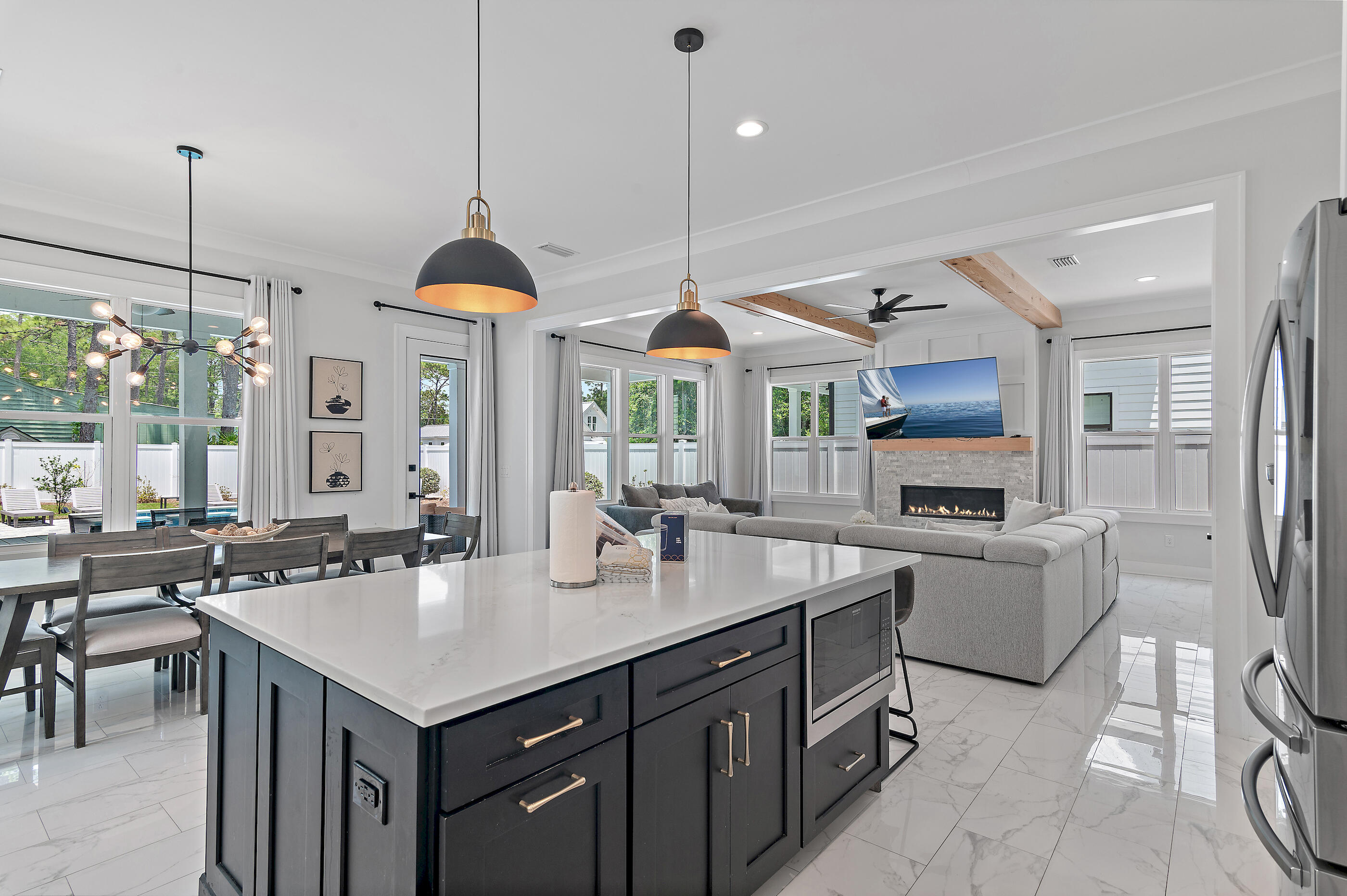 13 Jp Lane Santa Rosa Beach, FL 32459 - Photo 7 of 31 a kitchen with granite countertop a sink a center island a stove and a wooden floor