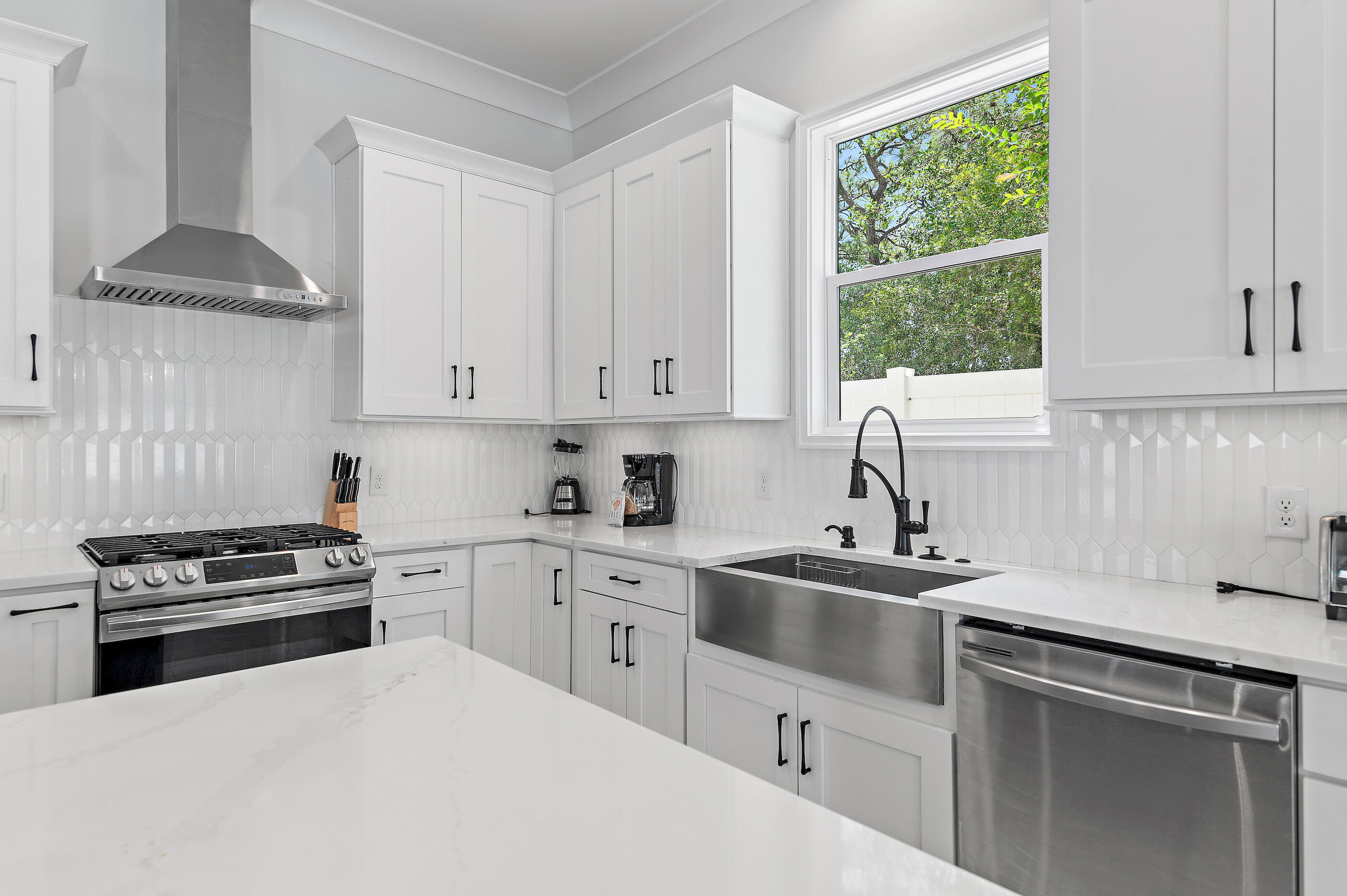 13 Jp Lane Santa Rosa Beach, FL 32459 - Photo 8 of 31 a kitchen with white cabinets and white appliances