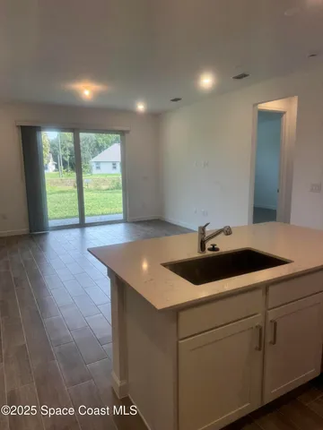 a kitchen with a sink and large window