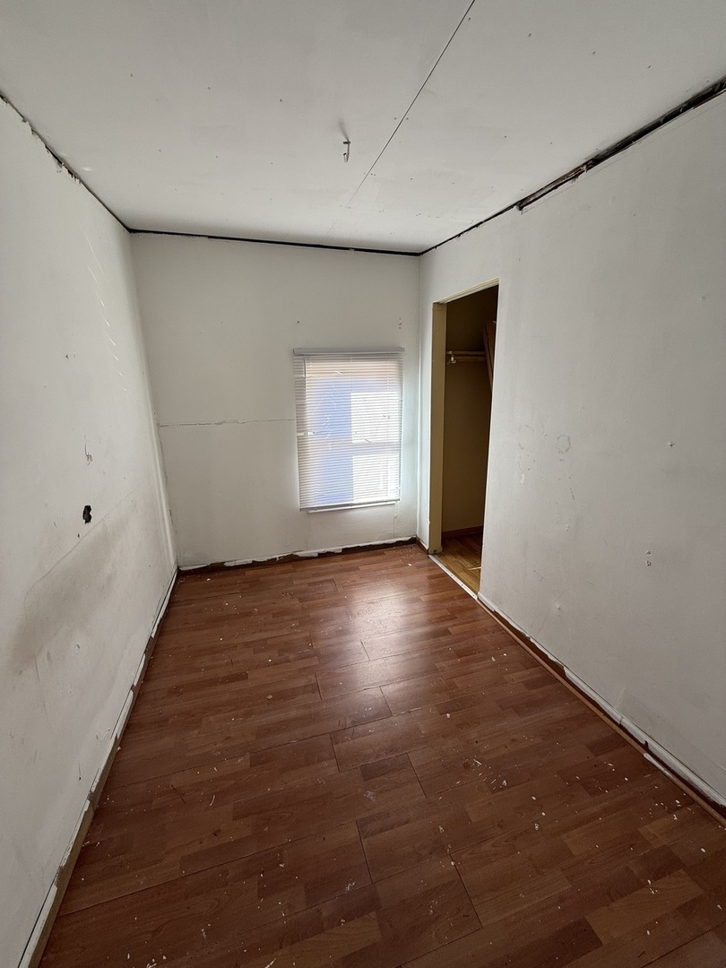 732 North Dearborn Avenue Kankakee, IL 60901 - Photo 13 of 21 an empty room with wooden floor and windows