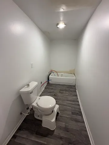 a bathroom with a toilet and a sink