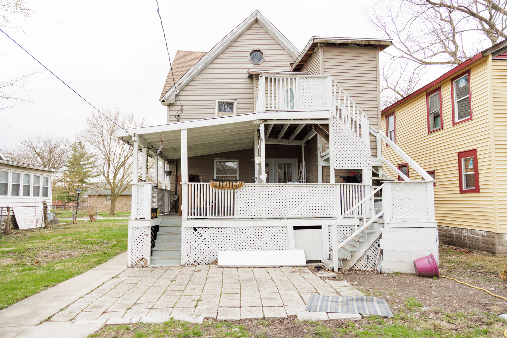 732 North Dearborn Avenue Kankakee, IL 60901 - Photo 16 of 21 a view of a white house with a small yard and wooden fence
