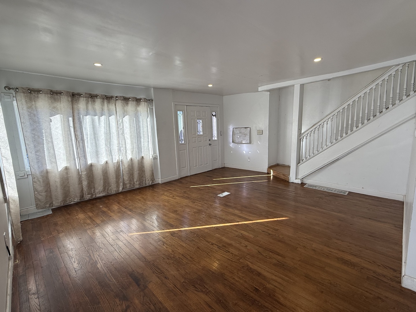 732 North Dearborn Avenue Kankakee, IL 60901 - Photo 4 of 21 a view of an empty room with wooden floor and a window