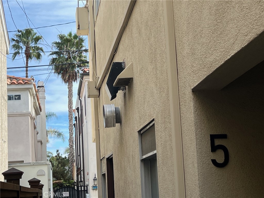 244 5th Street Seal Beach, CA 90740 - Photo 3 of 16 a vase with flowers sitting on a table in front of a window