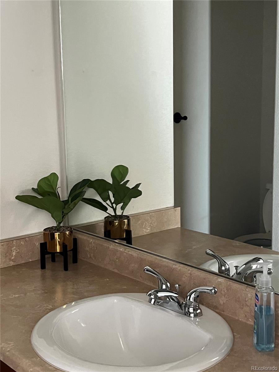 787 Rodgers Circle Platteville, CO 80651 - Photo 13 of 20 a bathroom with a sink and a mirror