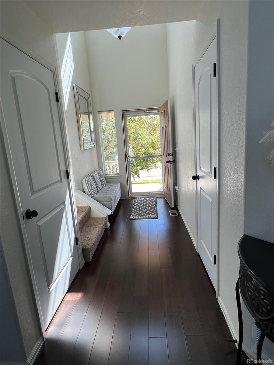 787 Rodgers Circle Platteville, CO 80651 - Photo 3 of 20 a view of entryway and hall with wooden floor