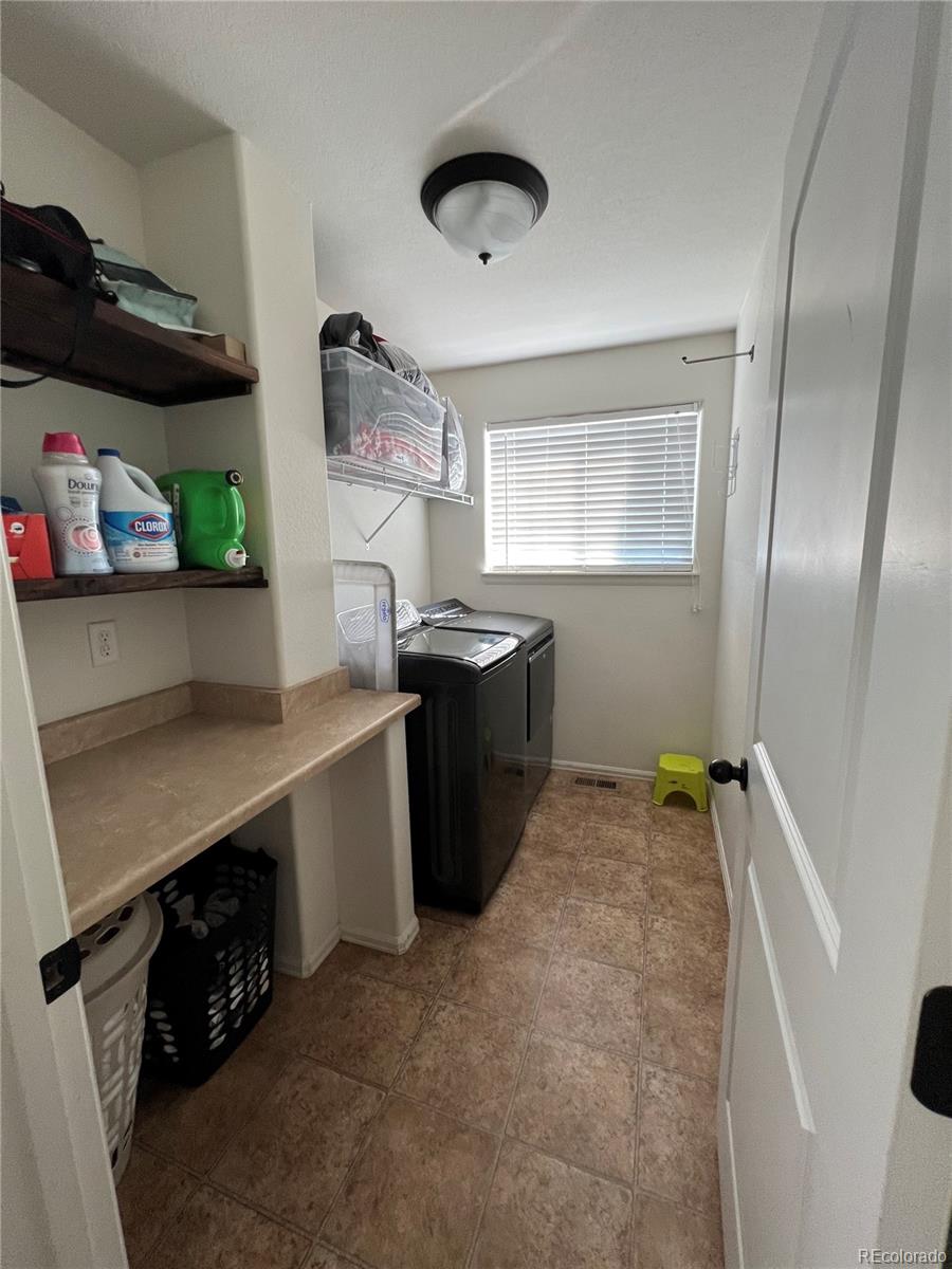 787 Rodgers Circle Platteville, CO 80651 - Photo 8 of 20 a kitchen with stainless steel appliances granite countertop a sink stove and refrigerator