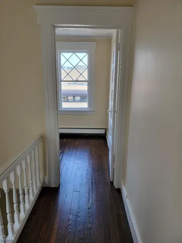 a view of hallway with wooden floor