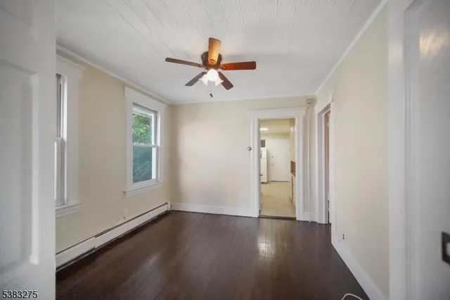 a view of a livingroom with a ceiling fan and window