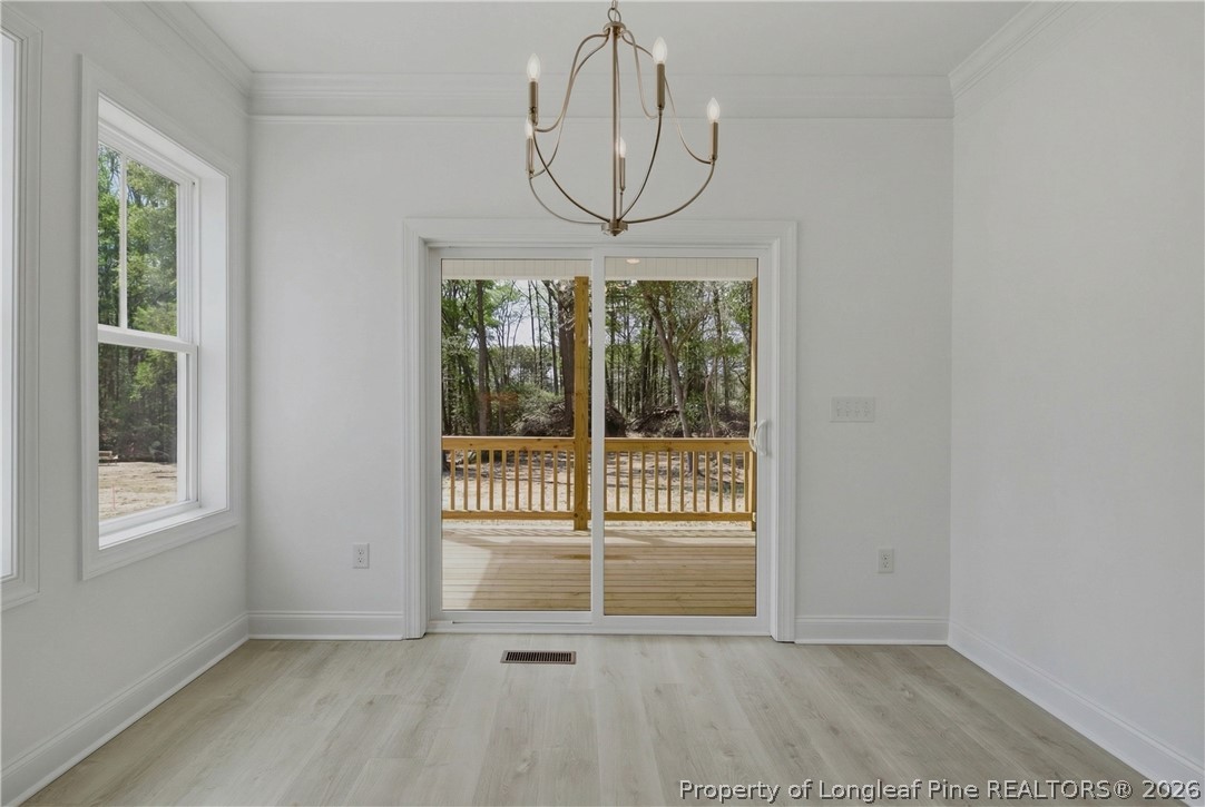 3187 Leaflet Church Road Broadway, NC 27505 - Photo 9 of 27 a view of a room with wooden floor and windows