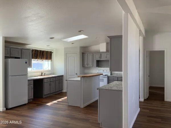 a kitchen with a sink cabinets and wooden floor