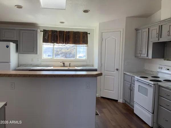 an empty room with wooden floor and cabinet