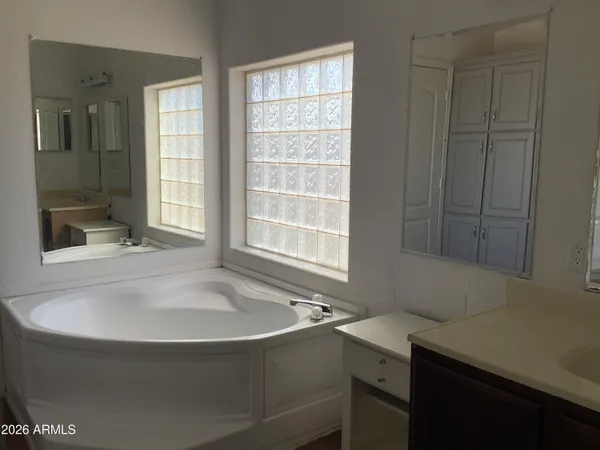 a view of a closet area with hardwood floor