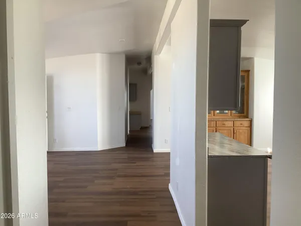 a view of hallway with windows and wooden floor