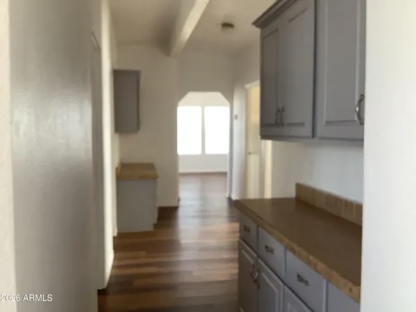 an empty room with wooden floor and a window