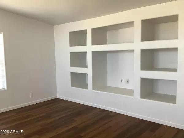 an empty room with wooden floor and closet