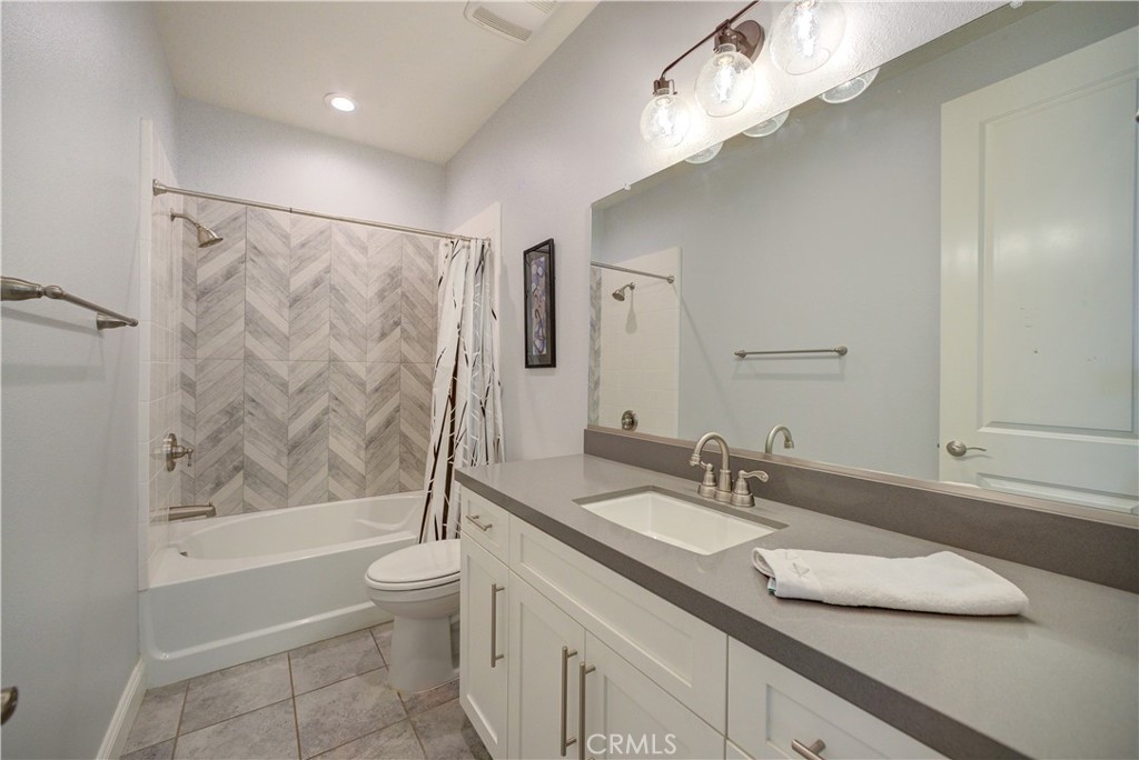 851 Trail View Place Nipomo, CA 93444 - Photo 18 of 47 a bathroom with a granite countertop sink a toilet and shower