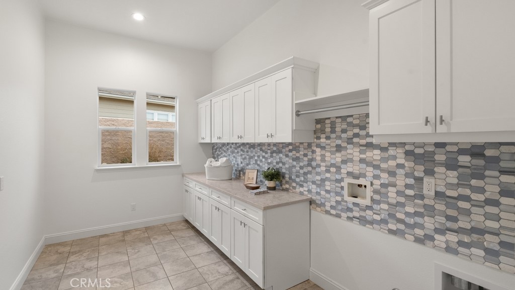 851 Trail View Place Nipomo, CA 93444 - Photo 32 of 47 a bathroom with granite countertop white cabinets and a sink