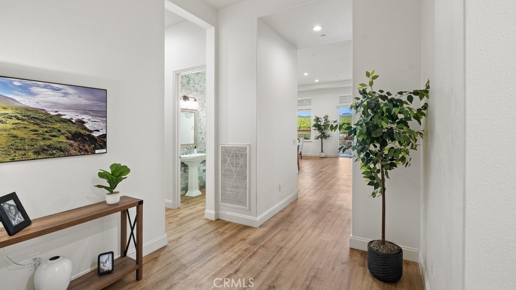 851 Trail View Place Nipomo, CA 93444 - Photo 4 of 47 a view of a hallway with wooden floor and a potted plant