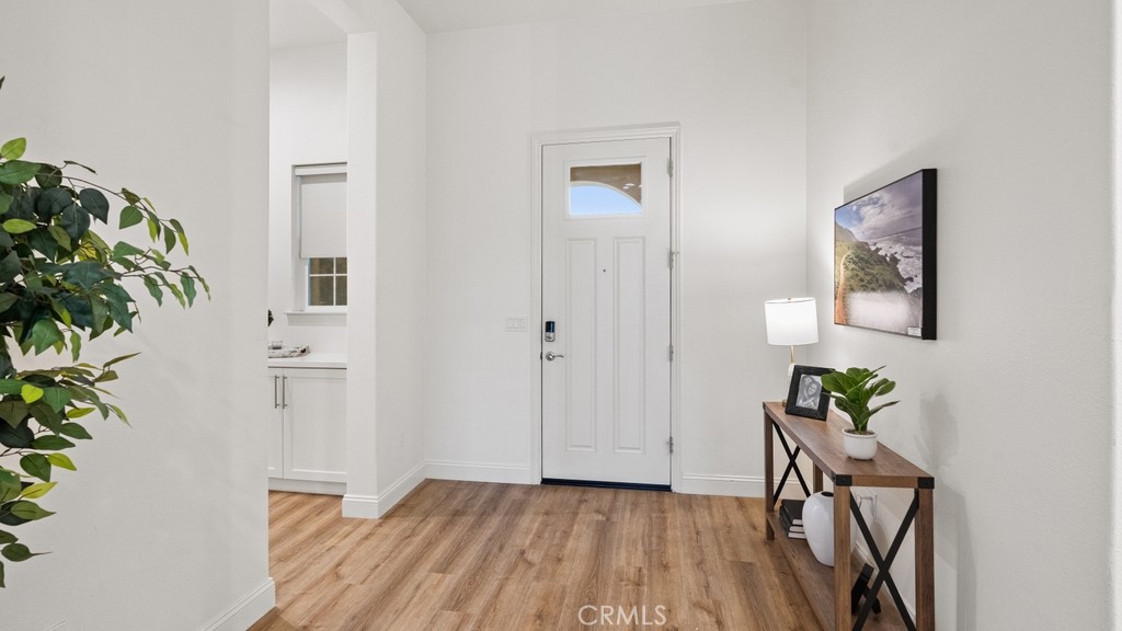 851 Trail View Place Nipomo, CA 93444 - Photo 5 of 47 a view of a hallway with wooden floor and a potted plant