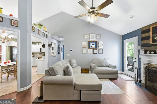 a living room with furniture a fireplace and a flat screen tv