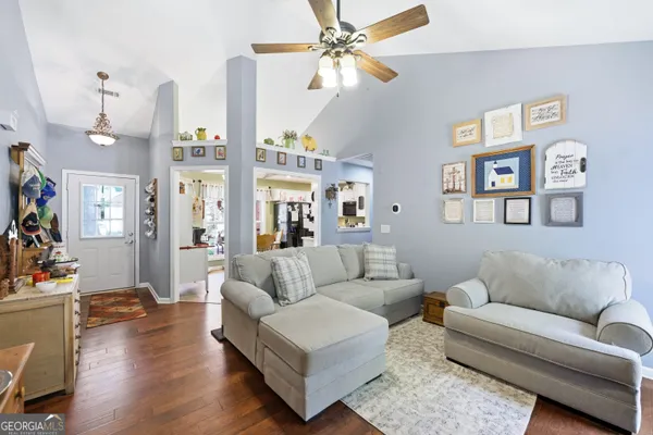 a living room with furniture or couch and a chandelier