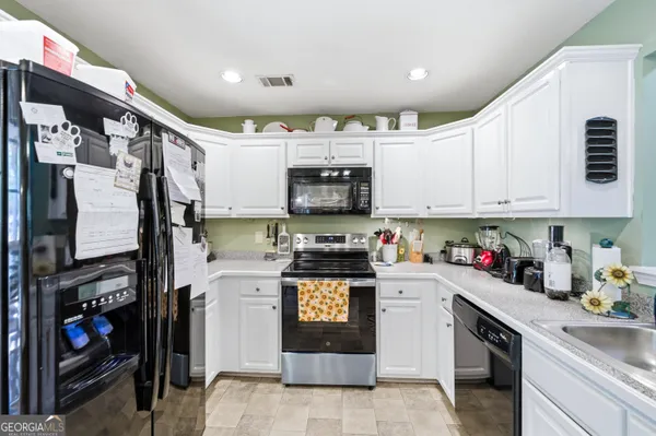 a kitchen with stainless steel appliances granite countertop a stove and cabinets