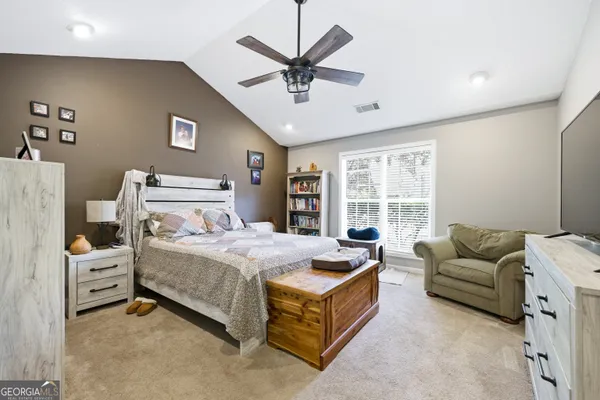 a bedroom with furniture and windows