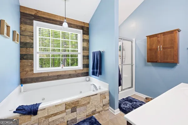 a bathroom with a tub and a window