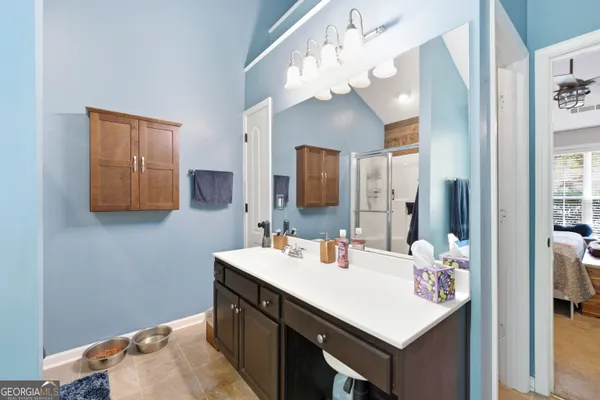 a bathroom with a sink vanity and a mirror