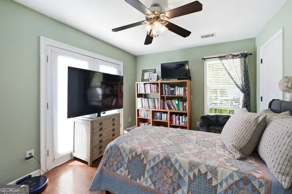 a bedroom with a bed and a flat screen tv